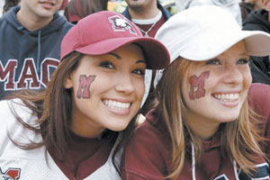 Girls with McMaster 'M' facepainting on cheeks